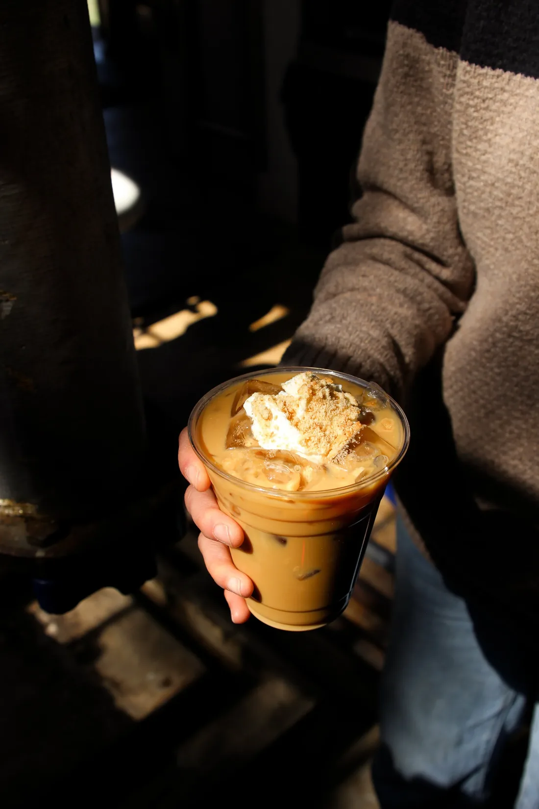 Iced TRRBL latte topped with whipped cream and wafer crumbles